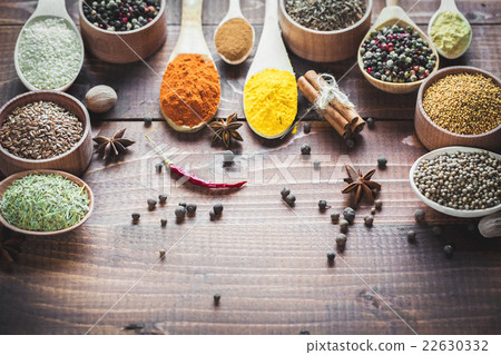 Beautiful colorful spices in wooden spoons  22630332