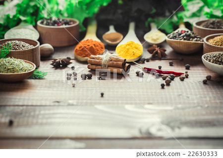 Beautiful colorful spices in wooden spoons 22630333