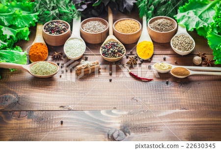 Beautiful colorful spices in wooden spoons  22630345
