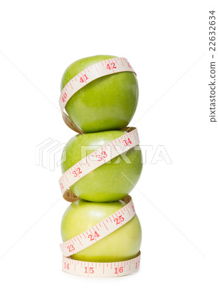 Stacked apples with a tape measure, isolated 22632634