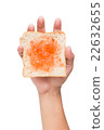Hand holding a piece of bread with jam isolated 22632655