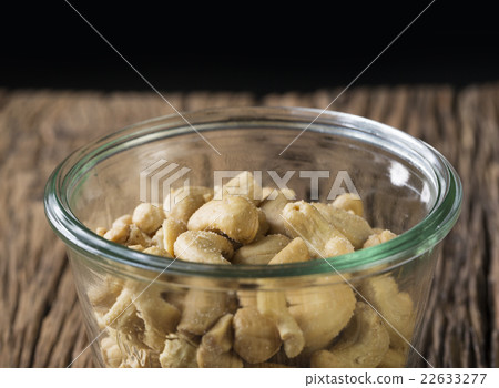 Bowl of cashew nuts on a rustic wood table. Bowl of cashew nuts on a rustic wood table. 22633277