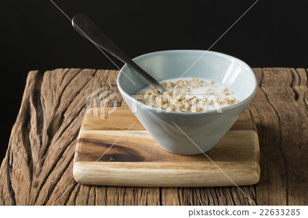 A bowl of muesli on a rustic wooden table. A bowl of muesli on a rustic wooden table. 22633285