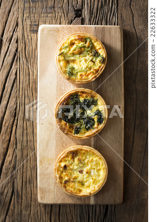 Three homemade quiche's on a rustic background. Three homemade quiche's on a rustic background. 22633322