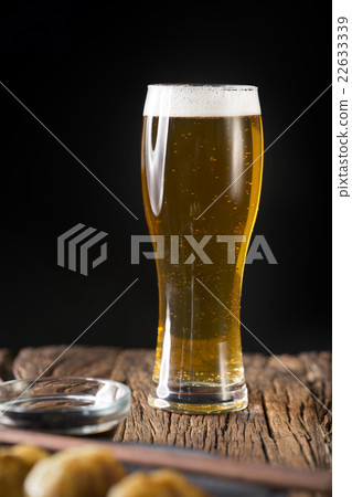 Craft Beer sitting on a rustic wooden bar. Craft Beer sitting on a rustic wooden bar. 22633339