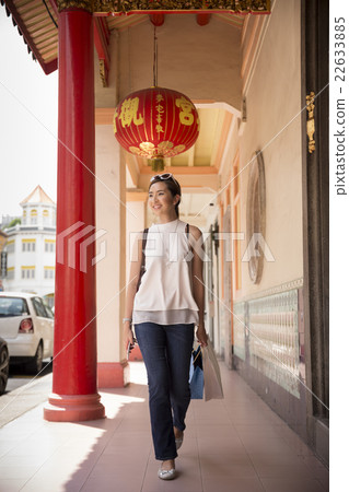 Portrait of a happy Asian woman shopping. 22633885