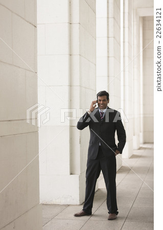 Indian business man talking on his Smart phone. Indian business man talking on his Smart phone. 22634121