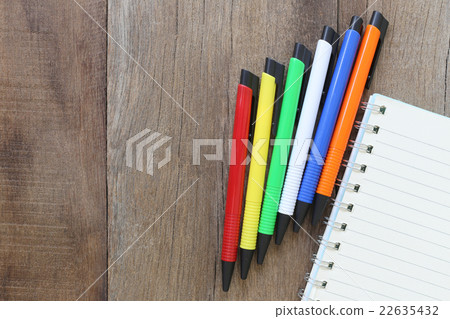 Notebook and pen on old wood for the design background. Notebook and pen on old wood for the design background. 22635432