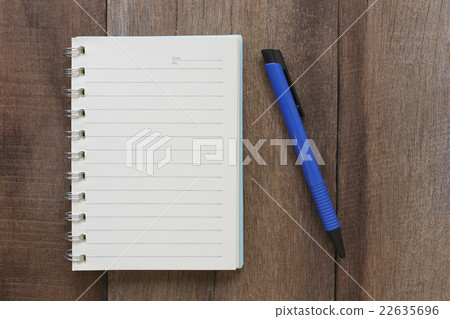 Notebook and pen on old wood for the design background. Notebook and pen on old wood for the design background. 22635696
