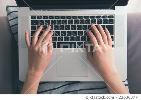 Over view of Laptop and woman's hands on laptop. Over view of Laptop and woman's hands on laptop. 22636377