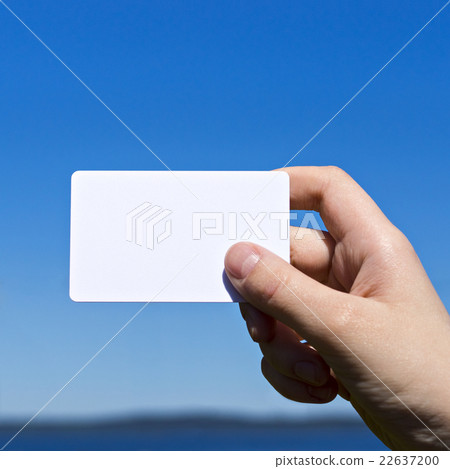 Hand presents white card on blue 22637200