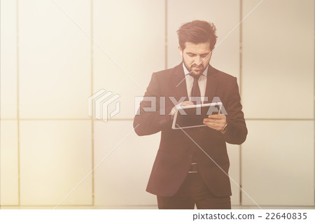 Businessman walking with tablet PC 22640835