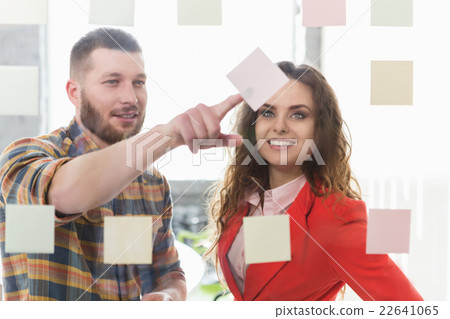 Businessman and businesswoman working in office Businessman and businesswoman working in office 22641065