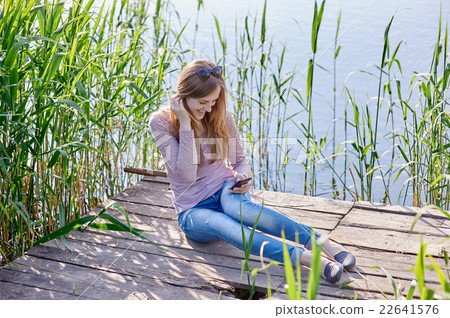 beautiful woman sitting on wooden pier the river beautiful woman sitting on wooden pier the river 22641576