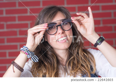 Woman trying out a double eyesight glasses Woman trying out a double eyesight glasses 22641603