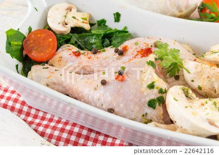 Raw chicken wings in a bowl covered with spices 22642116