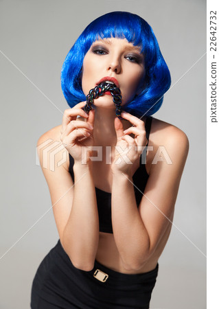 Woman with blue hair biting necklace Woman with blue hair biting necklace 22642732