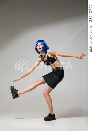 Smiling woman in blue wig in motion Smiling woman in blue wig in motion 22642742