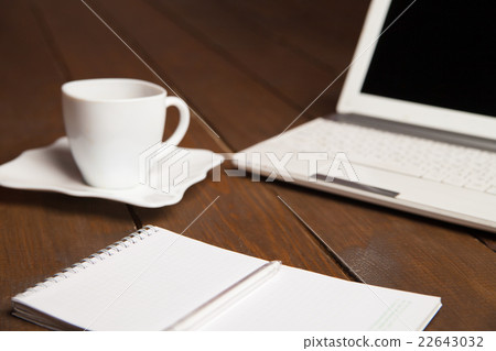 Cup of coffee,notebook and laptop on table 22643032