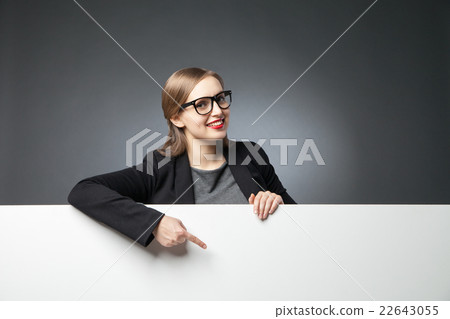 Smiling woman pointing at blank space 22643055