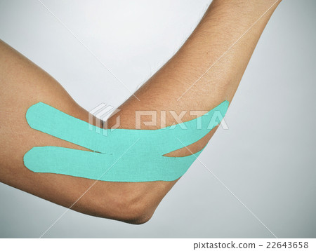 young man with an elastic therapeutic tape in his arm 22643658