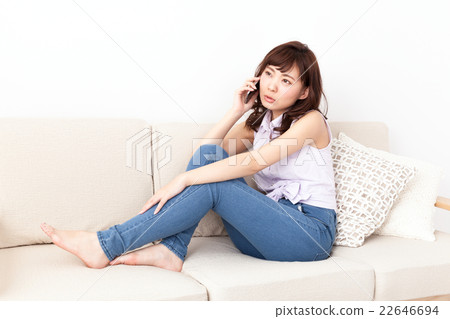 A young lady calling on the sofa A young lady calling on the sofa 22646694