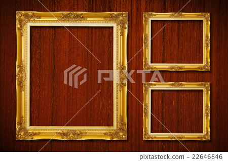 Golden frames on wood background 22646846