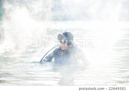 Woman diver in water shrouded in smoke Woman diver in water shrouded in smoke 22649381