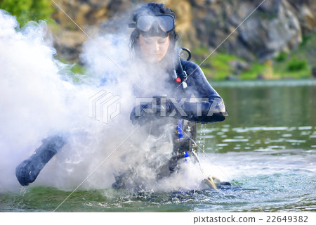 woman diver checking her gear. woman diver checking her gear. 22649382