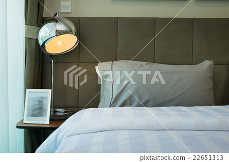 metal desk lamp and grey pillow on bed metal desk lamp and grey pillow on bed 22651313