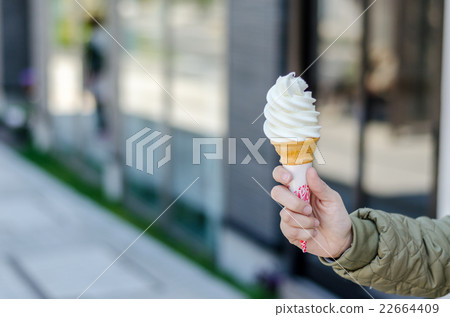 Hand holds conemilk ice cream at Otaru City. Hand holds conemilk ice cream at Otaru City. 22664409