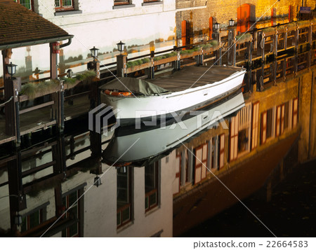Boat reflection on water canal by night 22664583