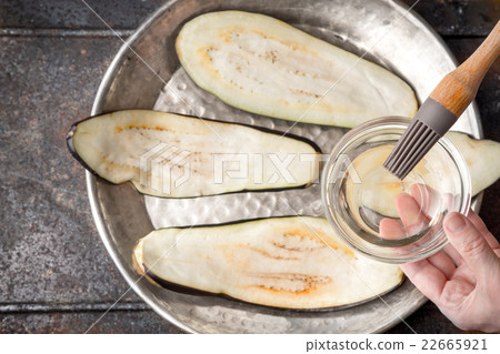 Brush the eggplant slices with olive oil top view 22665921