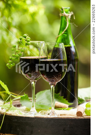 red wine bottle and glass on wodden barrel 22669263