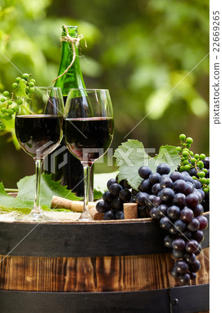 red wine bottle and glass on wodden barrel red wine bottle and glass on wodden barrel 22669265