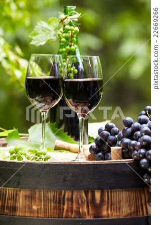 red wine bottle and glass on wodden barrel red wine bottle and glass on wodden barrel 22669266