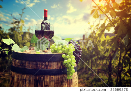 red wine bottle and glass on wodden barrel red wine bottle and glass on wodden barrel 22669278
