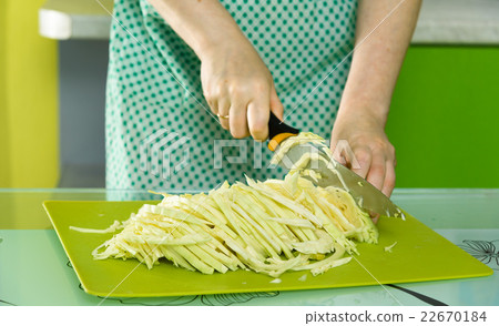 women's hands cut the cabbage on green chalkboard 22670184