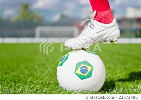 Foot on soccer ball with Brazil's flag 22672480