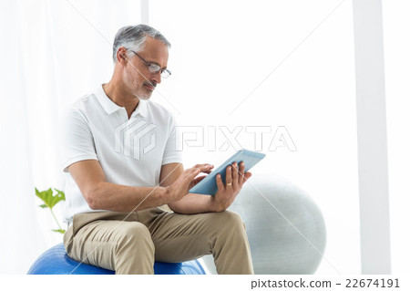 Physiotherapist using digital tablet Physiotherapist using digital tablet 22674191
