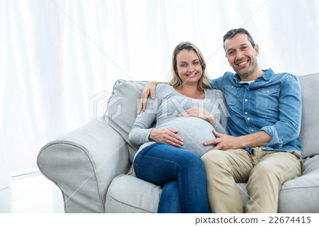 Couple sitting on sofa 22674415