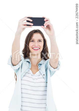 Smiling young woman taking a selfie Smiling young woman taking a selfie 22674499
