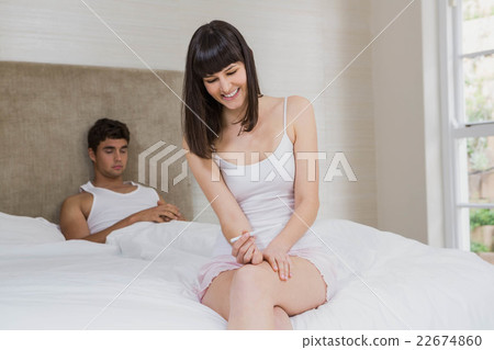 Happy young woman with pregnancy test 22674860