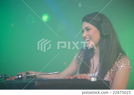 Pretty female DJ playing music 22675025
