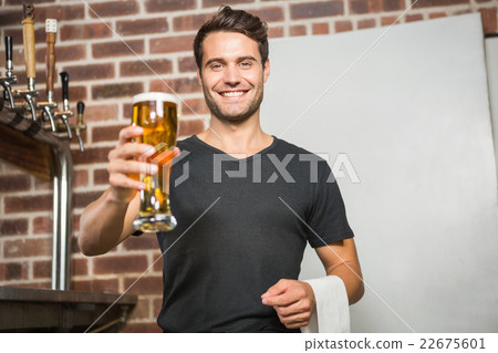 Handsome man holding a pint of beer 22675601