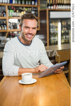 Handsome man using tablet computer 22675621
