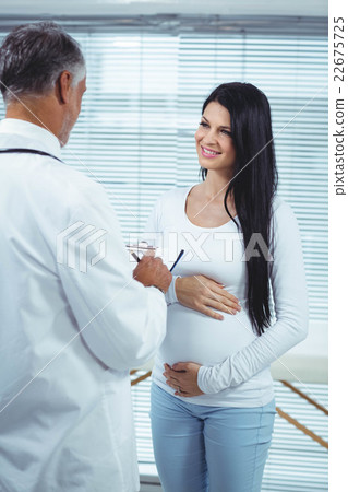 Pregnant woman interacting with doctor Pregnant woman interacting with doctor 22675725