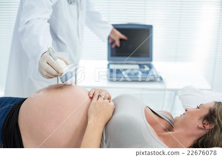Pregnant woman receiving ultrasound treatment 22676078