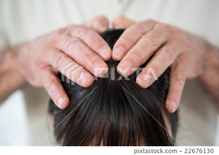 Close-up of woman receiving a head massage 22676130