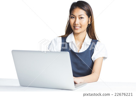 Smiling businesswoman using a laptop 22676221